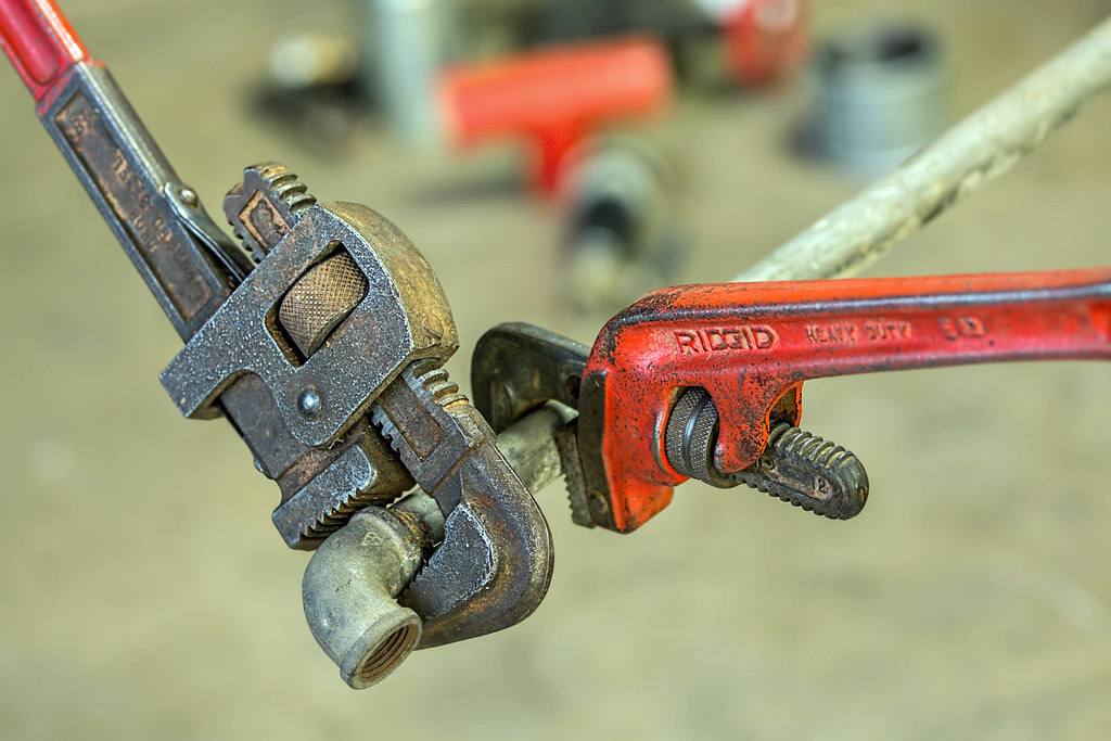 Pipe wrenches on a copper fitting